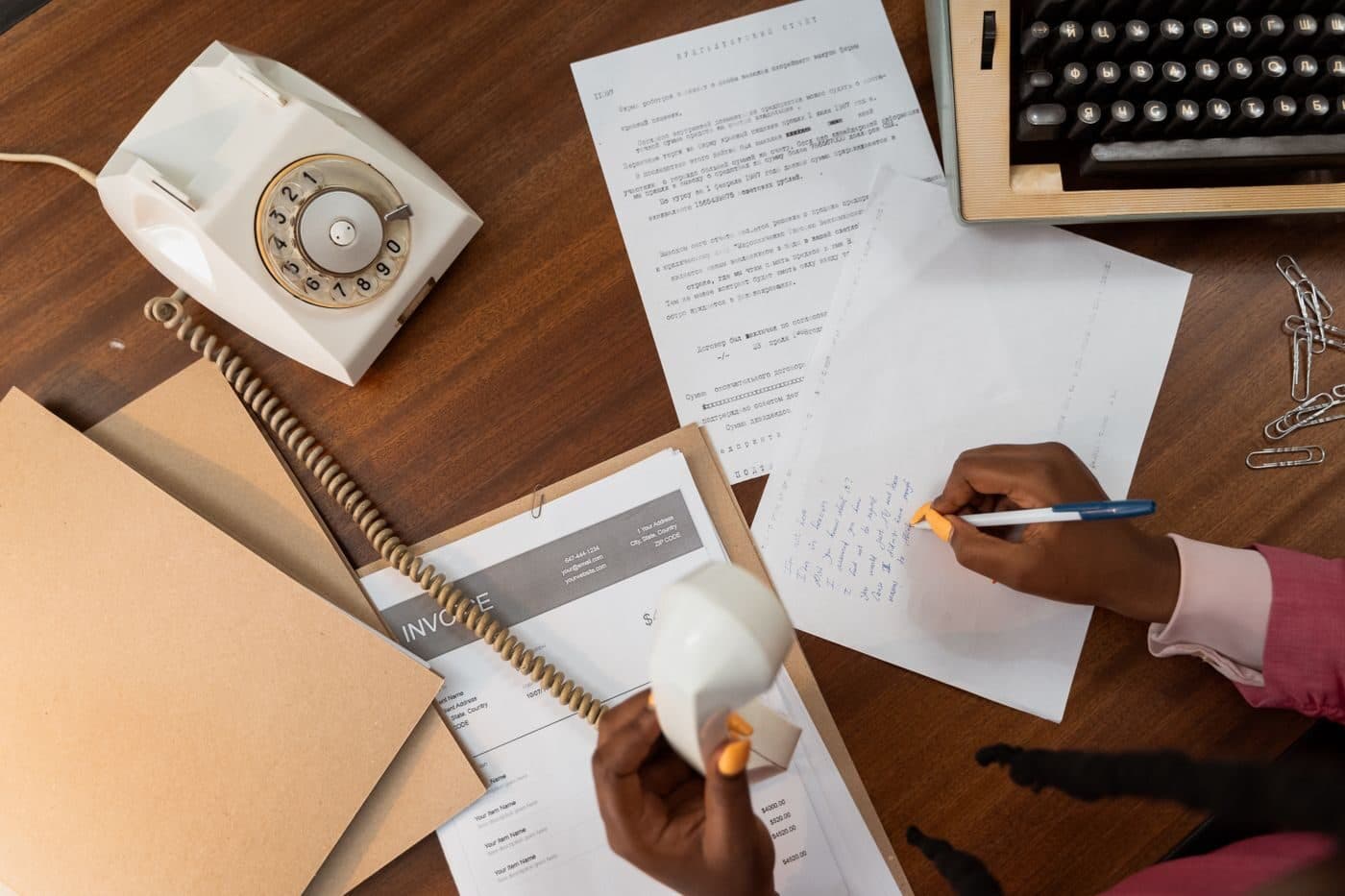 Notes being written beside a telephone on a desk