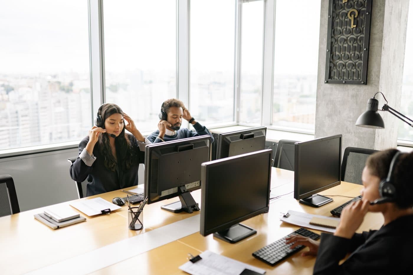 An operations team working at desks with headsets