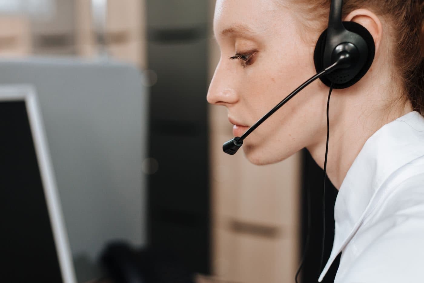 A call-centre agent wearing a headset at their desk