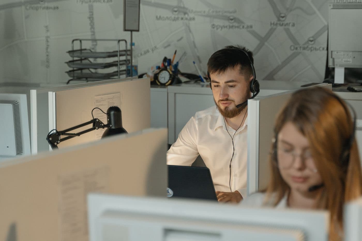 Call centre agents working at their desks wearing headsets