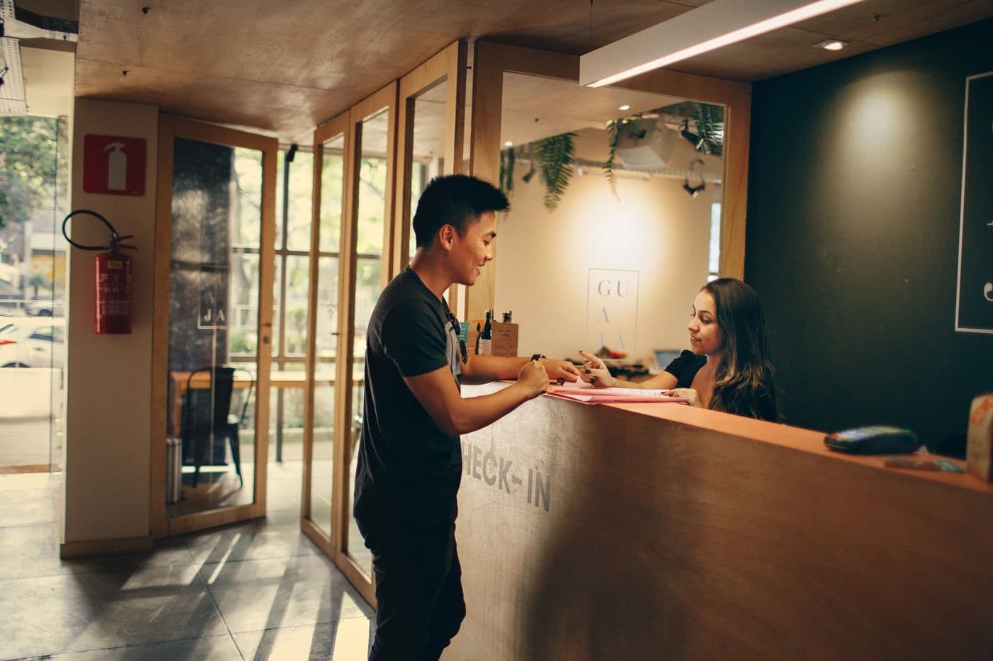 A customer checking in at a hotel reception desk