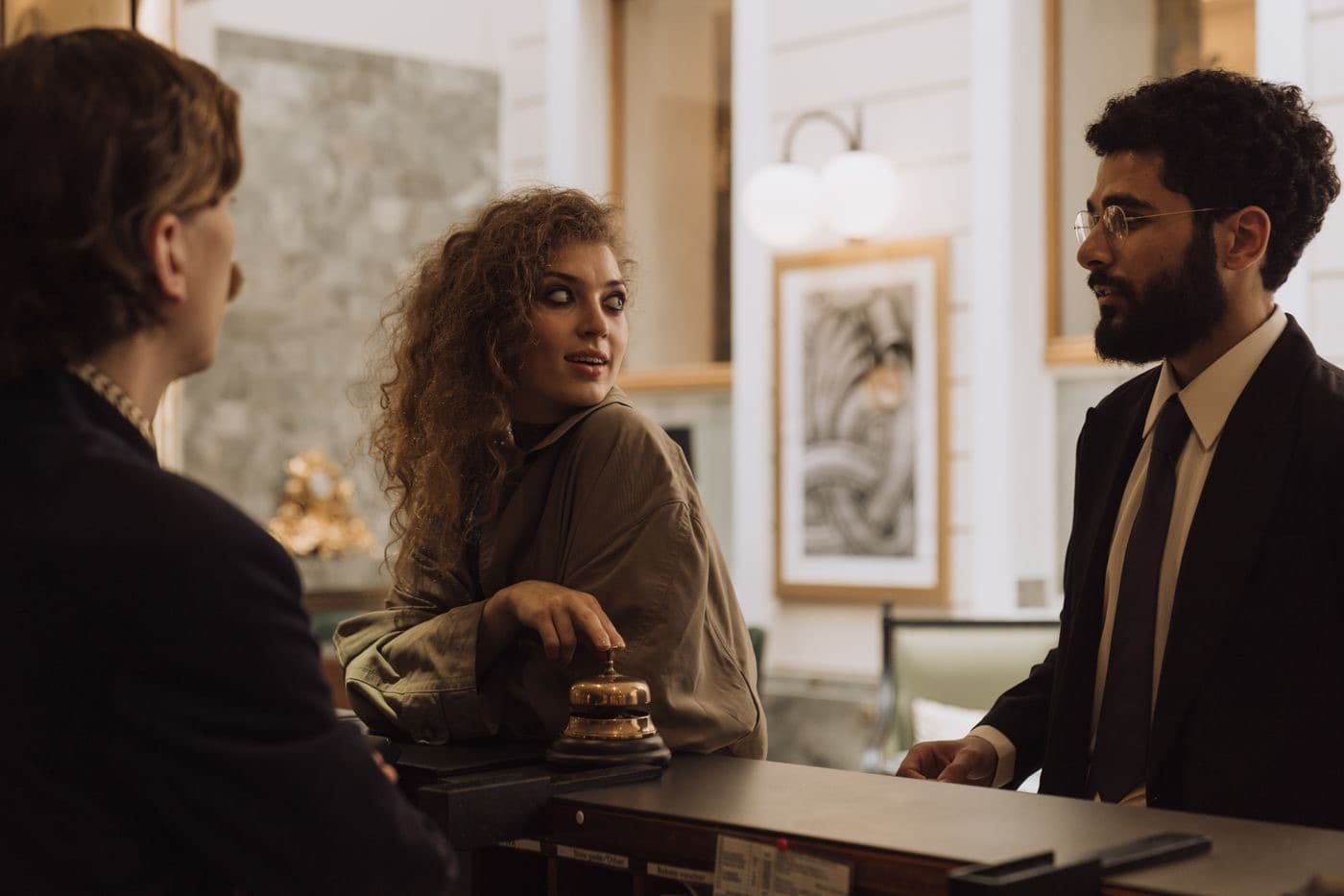 Guests interacting at a hotel reception desk
